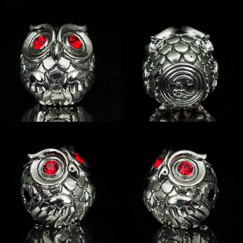 Thai owl charm for luck and prosperity in silver with red gemstones for a decorative touch