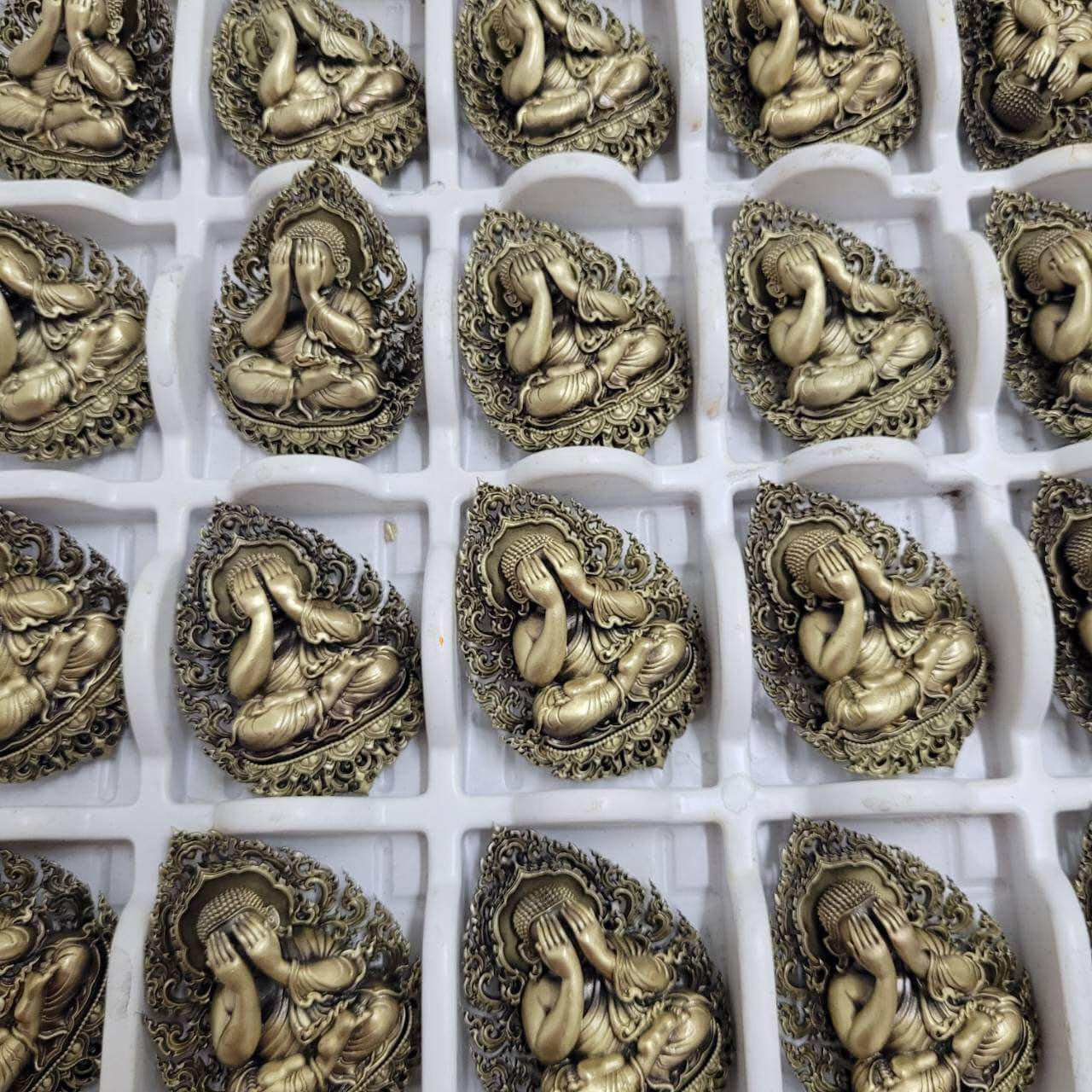 Collection of Thai Phra Pidta amulets for protection with intricate designs in gold finish