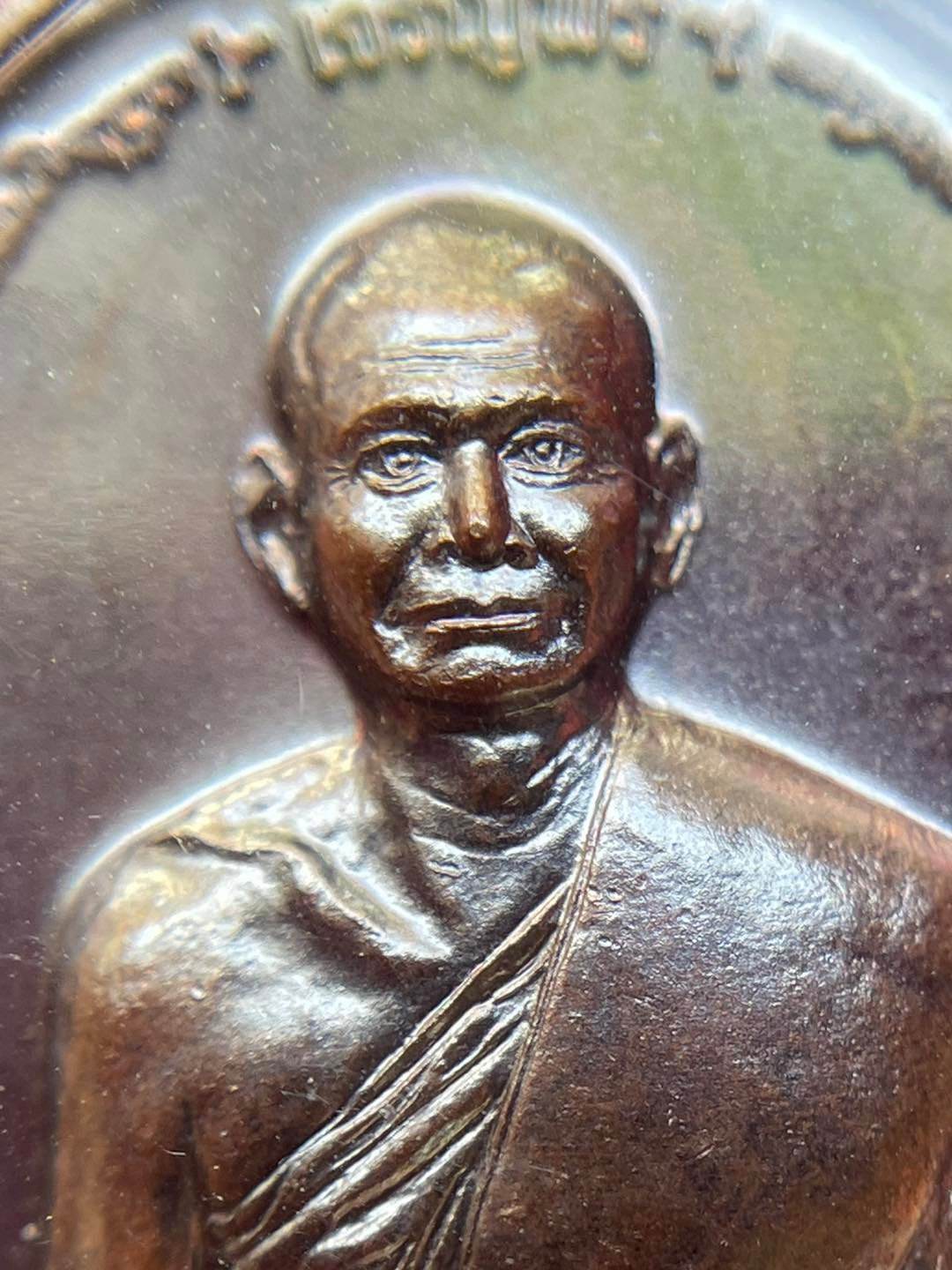 Detailed image of a Thai prosperity amulet for sale featuring a monk with intricate design
