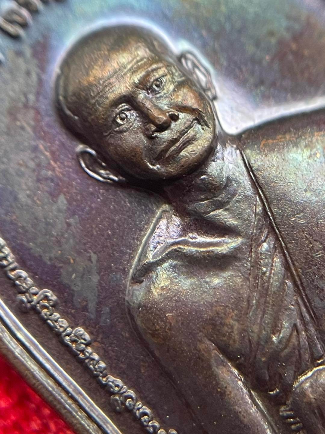 Thai prosperity amulet for sale featuring a detailed image of a revered monk's face
