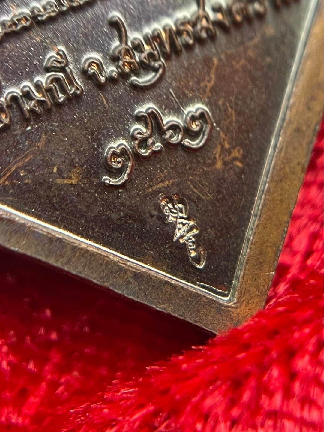 Close-up of a Thai prosperity amulet for sale showcasing intricate details and craftsmanship