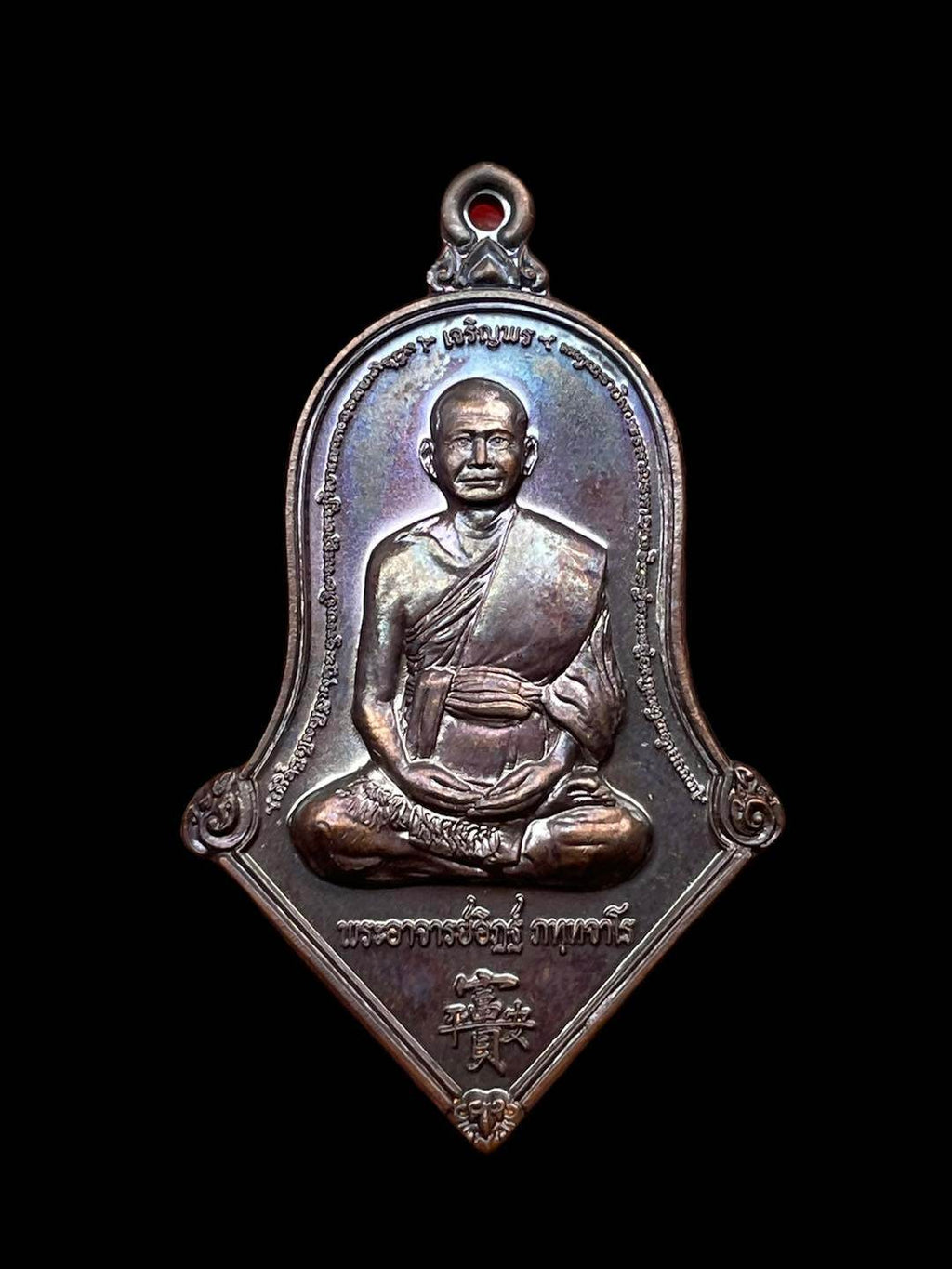 Thai prosperity amulet for sale featuring a detailed image of a revered monk in meditative pose