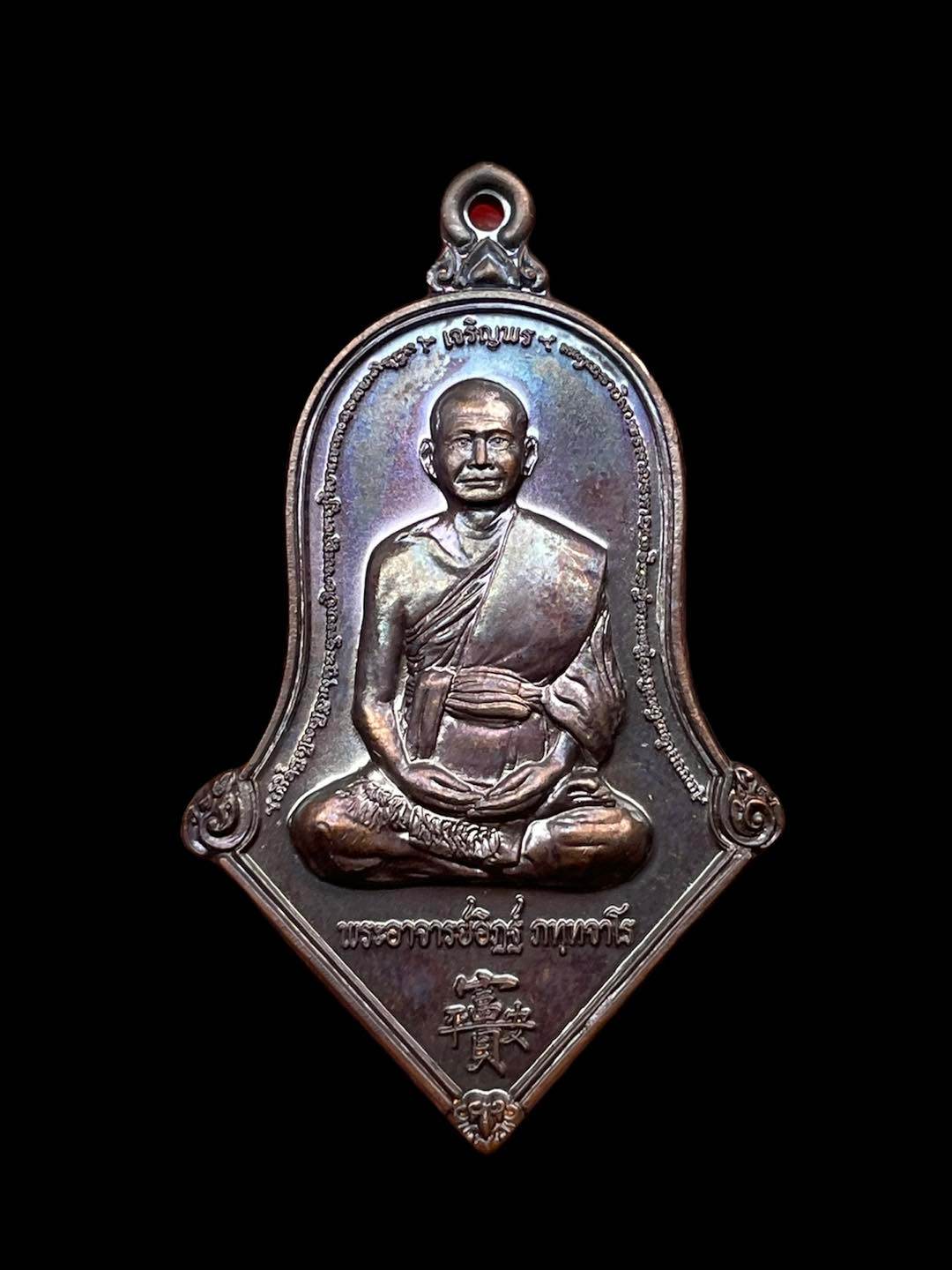Thai prosperity amulet for sale featuring a detailed image of a revered monk in meditative pose