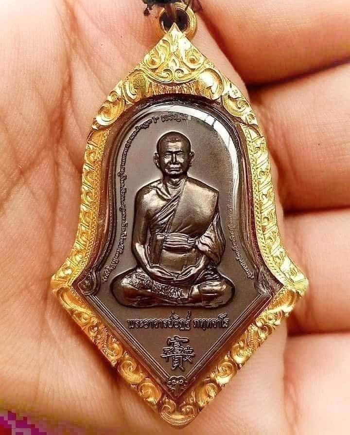Thai prosperity amulet for sale depicting a seated monk with intricate gold frame and detailing