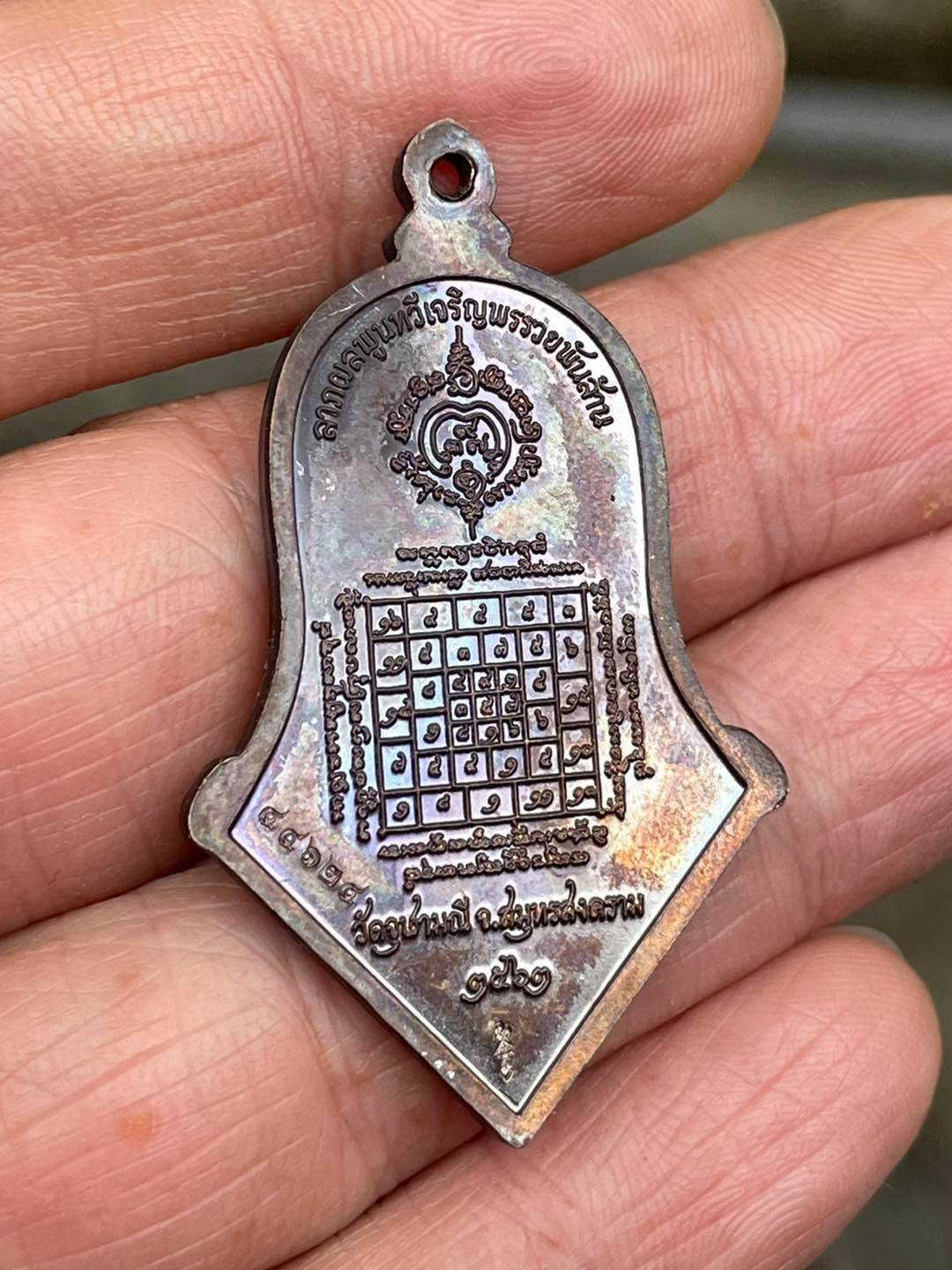 Thai prosperity amulet for sale featuring intricate designs and lucky symbols for good fortune