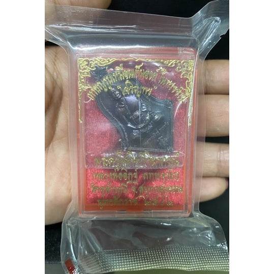 Thai prosperity amulet for sale in protective packaging featuring auspicious symbols for good fortune