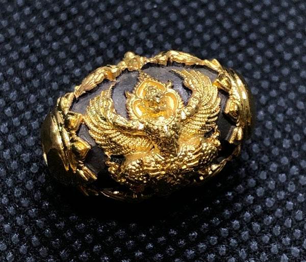 Thai protection amulet for prosperity featuring intricate gold detailing and a mystical design