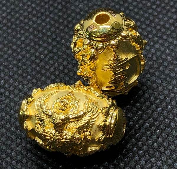 Gold Thai protection amulet for prosperity with intricate design and detailed carvings
