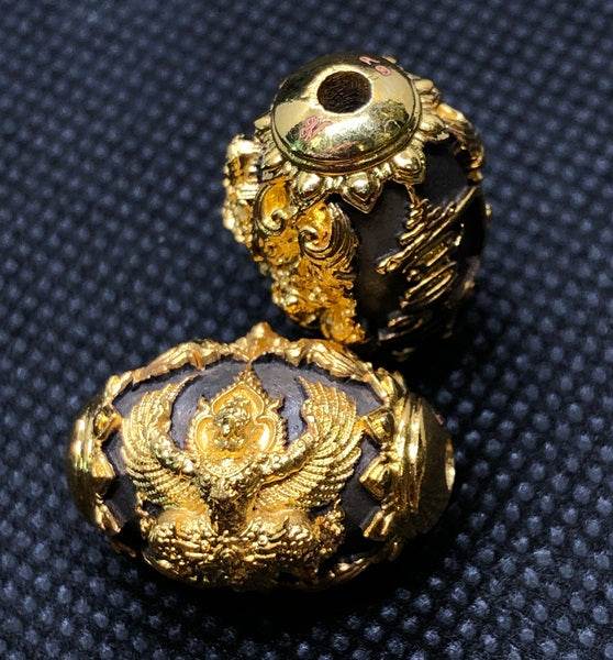 Intricately designed Thai protection amulet for prosperity featuring golden embellishments and detailed craftsmanship