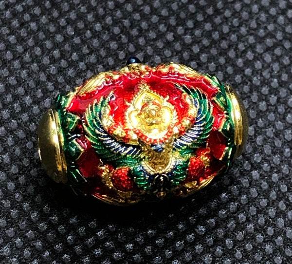 Colorful Thai protection amulet for prosperity with intricate detailing and gold accents