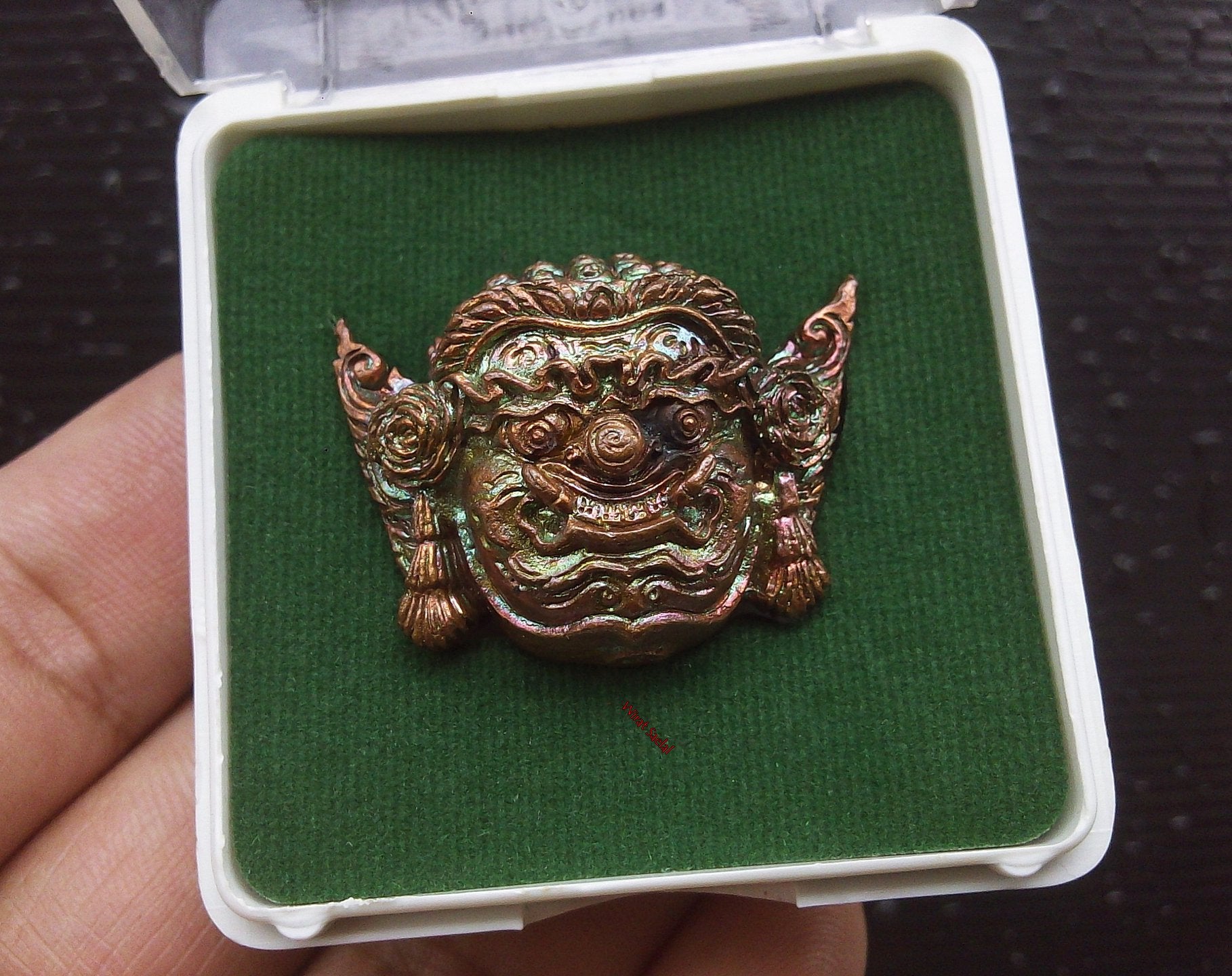 Thai protection amulet Rahu in ornate design, crafted by Thai Blessing Co, displayed in a protective case
