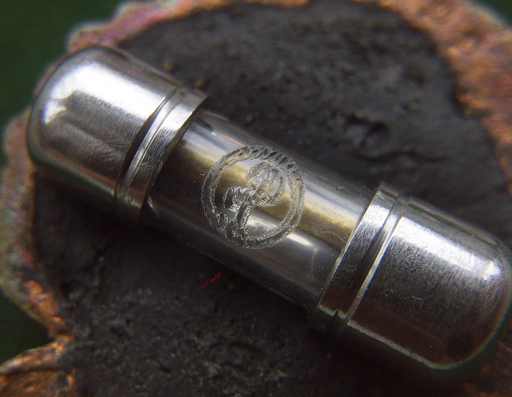 Thai protection amulet Rahu enclosed in a clear capsule for spiritual protection and energy