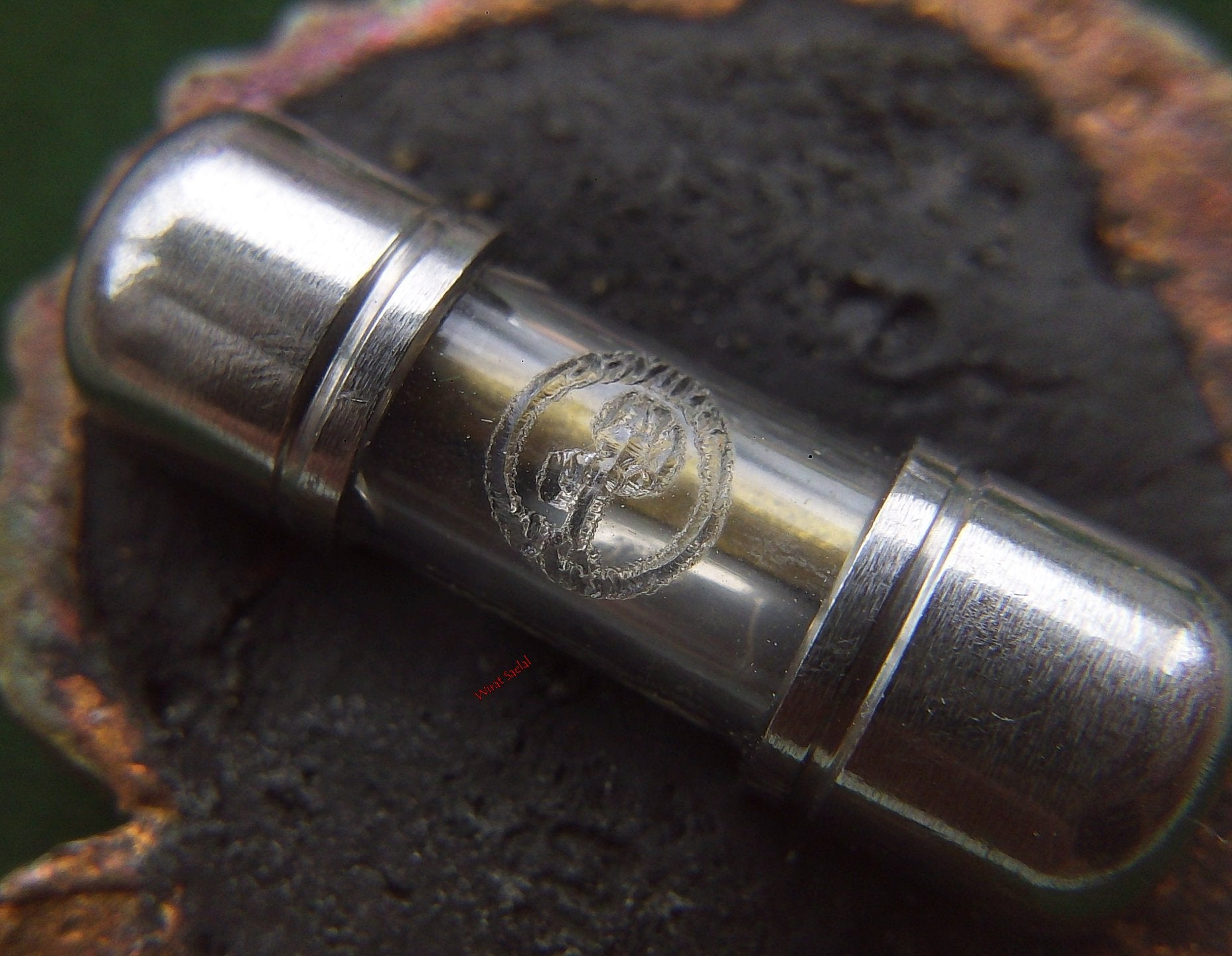 Thai protection amulet Rahu enclosed in a clear capsule for spiritual protection and energy