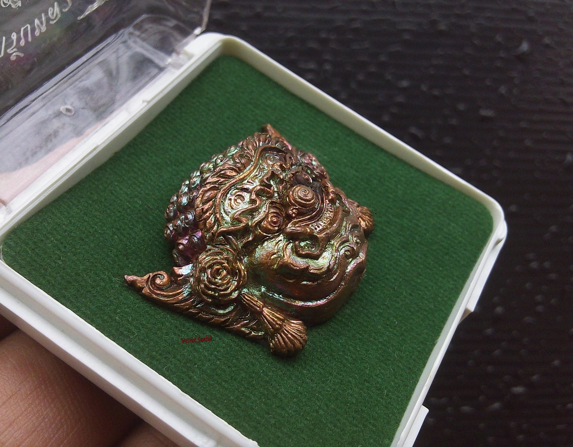 Thai protection amulet Rahu crafted with intricate details, displayed in a protective case