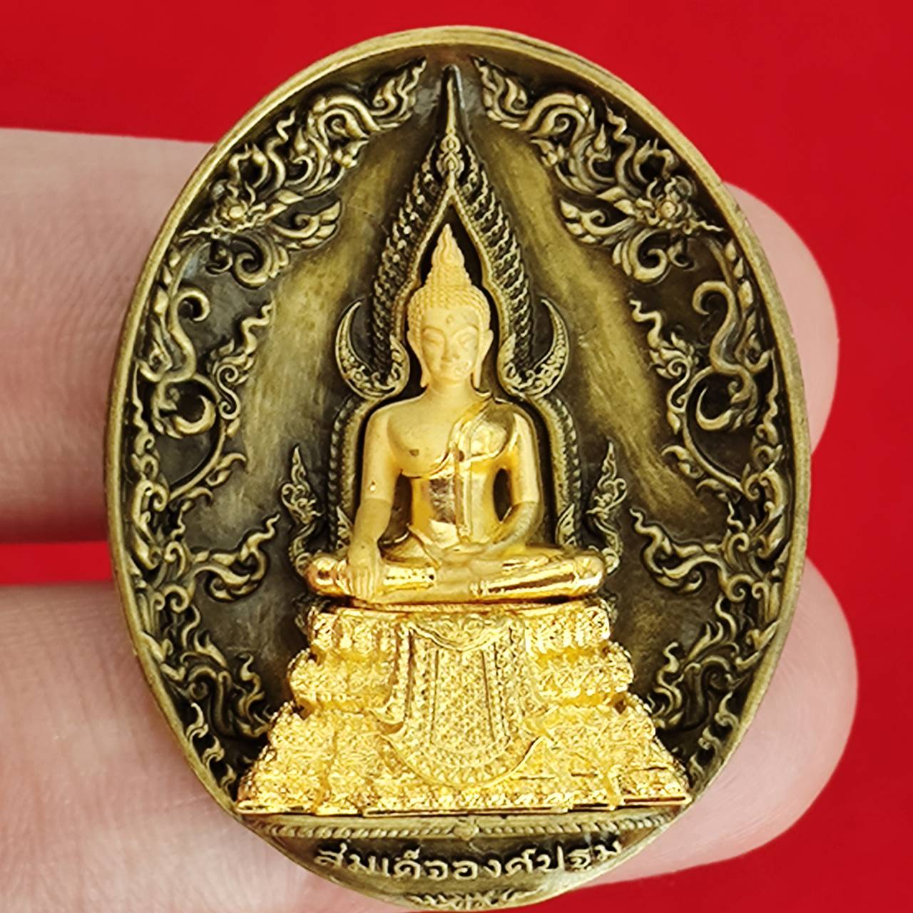 Thai protection fortune blessing charm featuring a detailed golden Buddha statue on an ornate background