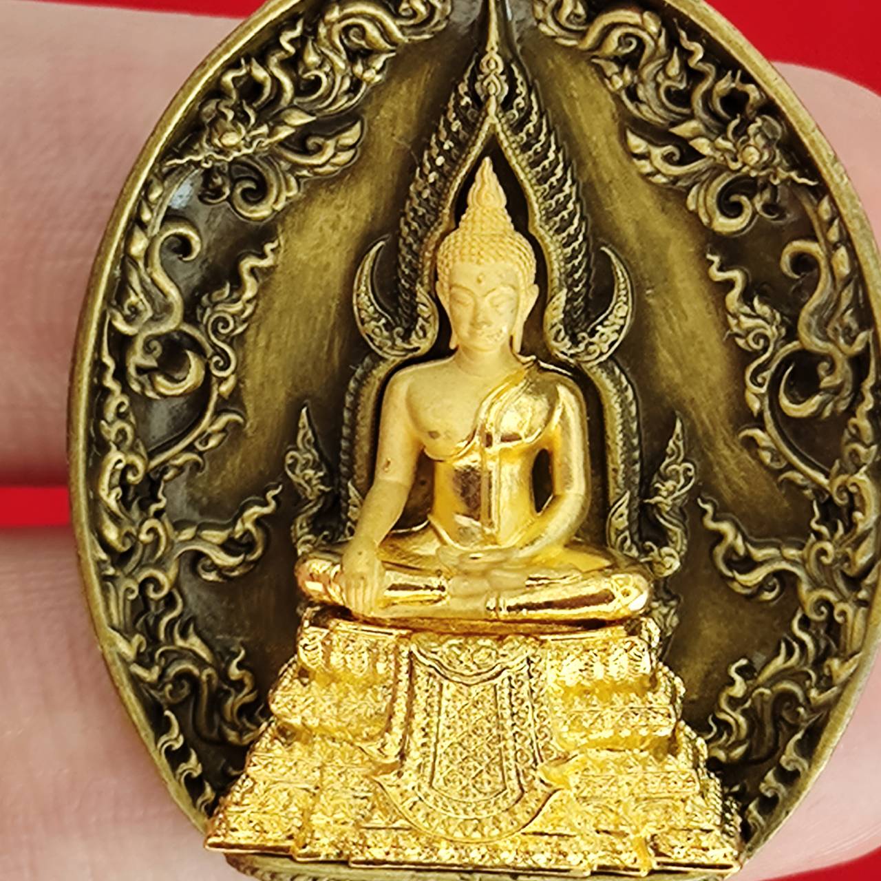 Thai protection fortune blessing charm featuring a golden Buddha statue with intricate detailing