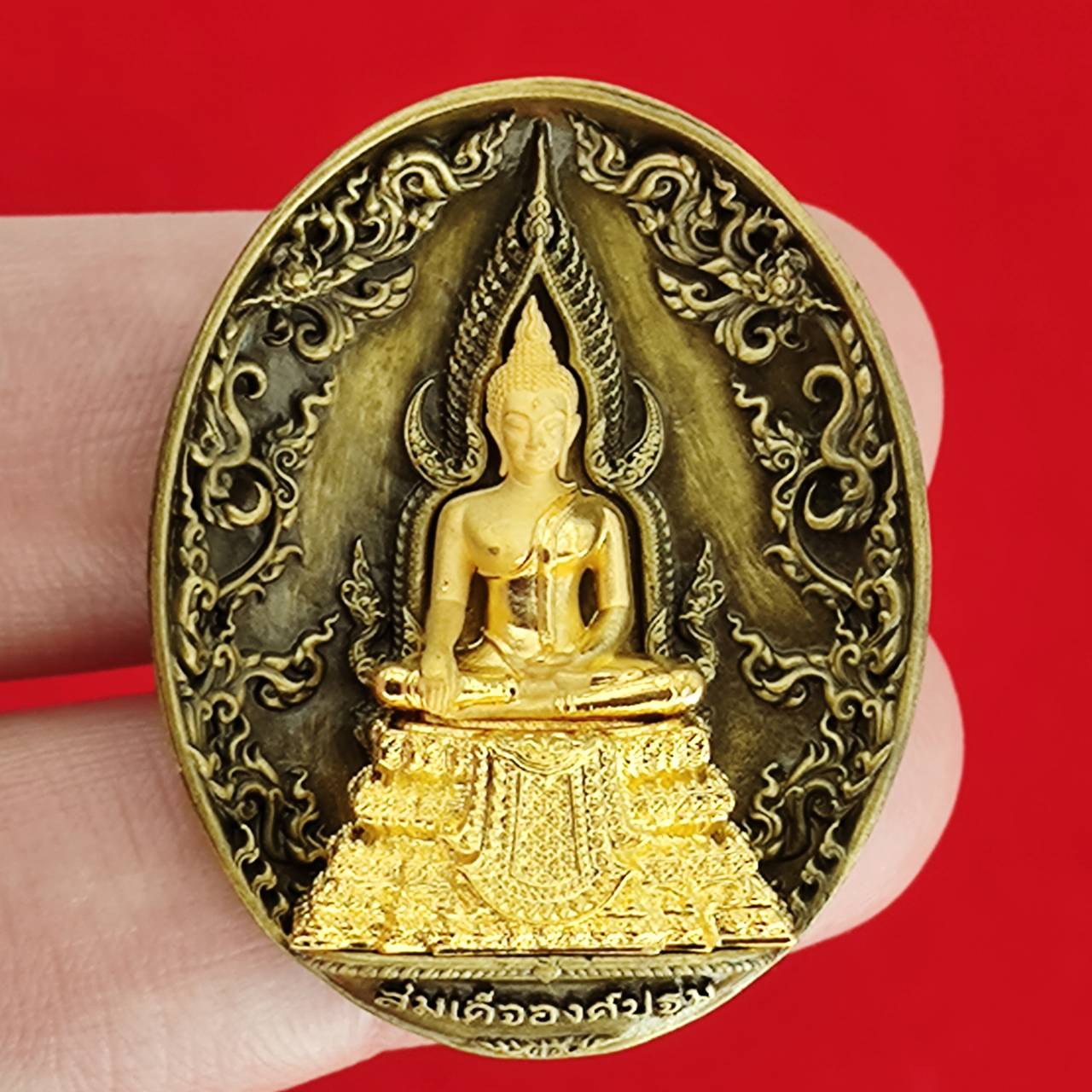 Thai protection fortune blessing charm featuring a golden Buddha statue on a decorative background