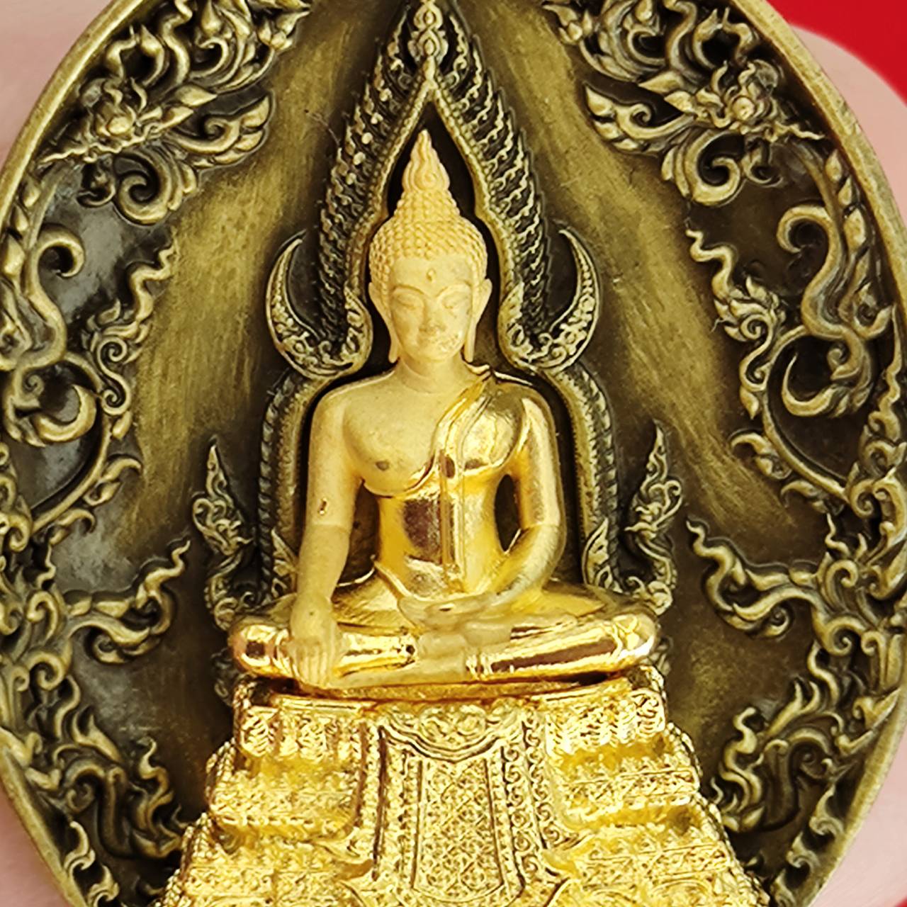 Thai protection fortune blessing charm featuring a detailed golden Buddha statue on ornate background