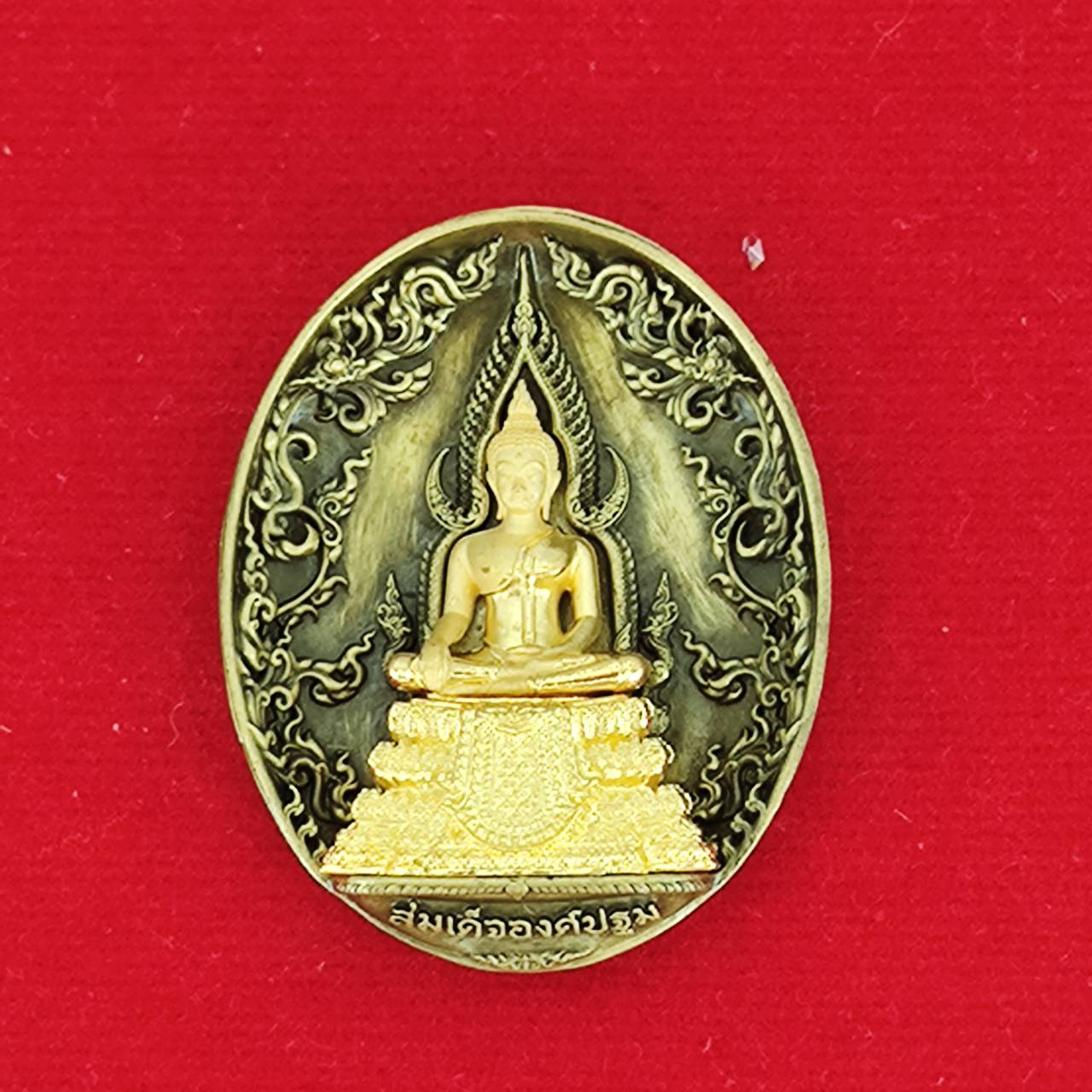 Thai protection fortune blessing charm featuring a detailed Buddha design on a red background