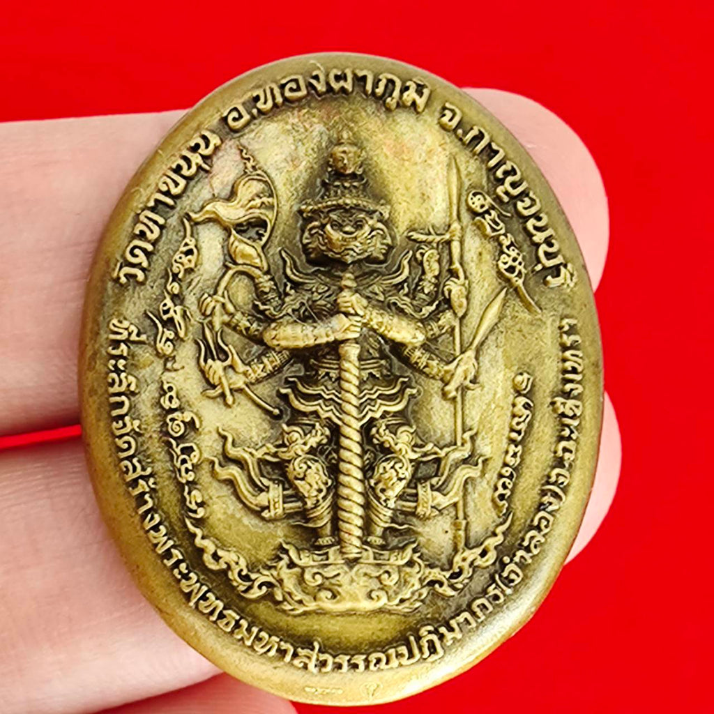 Thai protection fortune blessing charm intricately carved with religious symbols and designs