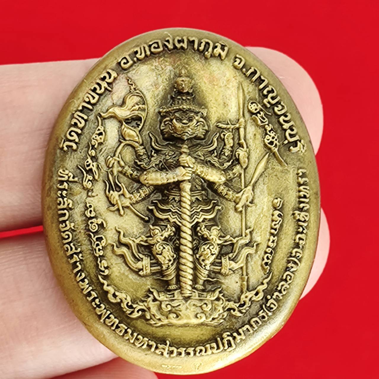 Thai protection fortune blessing charm intricately carved with religious symbols and designs