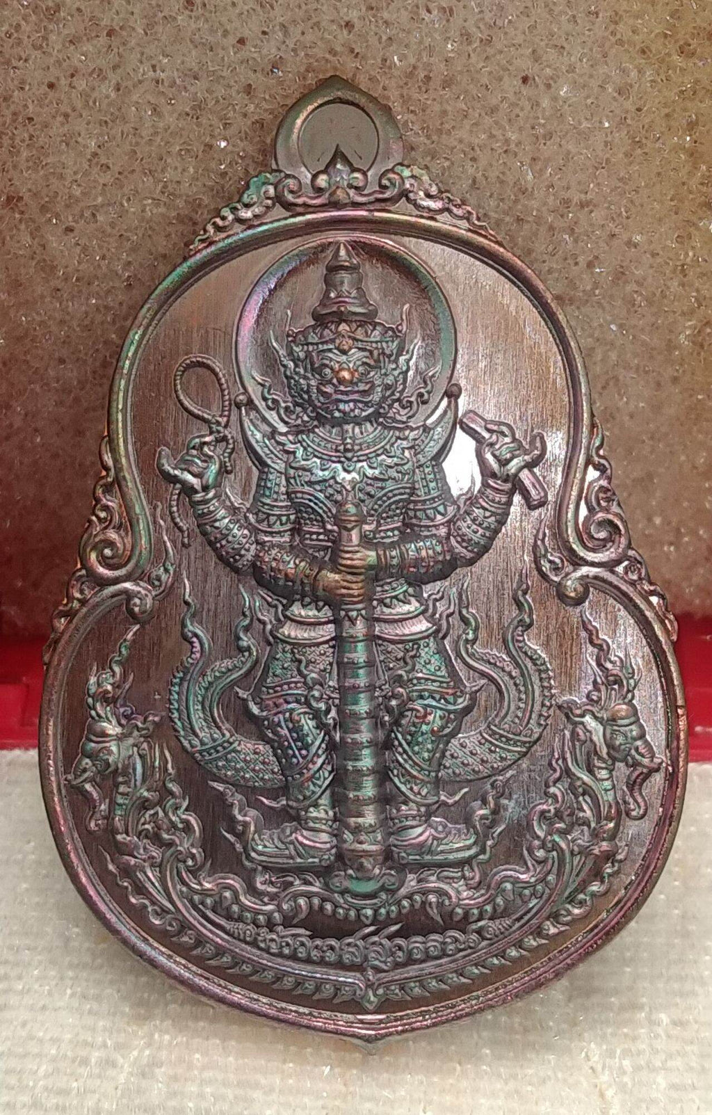 Thai protective talisman for wealth with detailed guardian figure and ornamental design by Thai Blessing Co