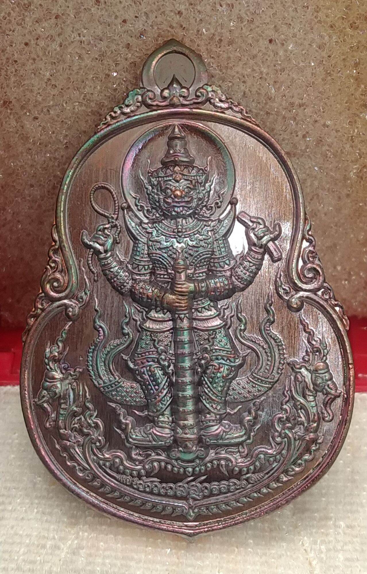 Thai protective talisman for wealth with detailed guardian figure and ornamental design by Thai Blessing Co
