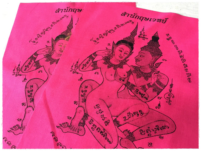 Two pink Thai sacred cloth for attraction featuring intricate designs and spiritual symbols