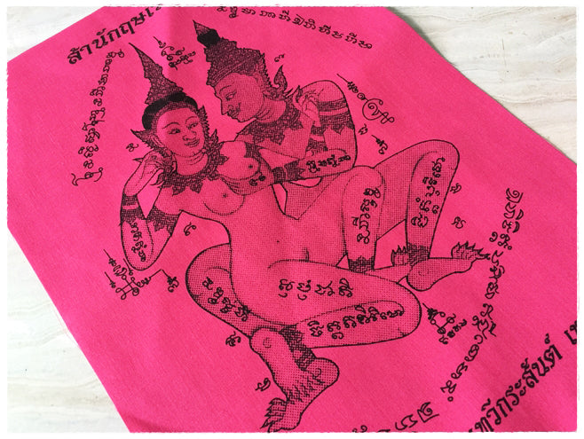 Thai sacred cloth for attraction featuring intricate deity designs and traditional symbols in vibrant pink