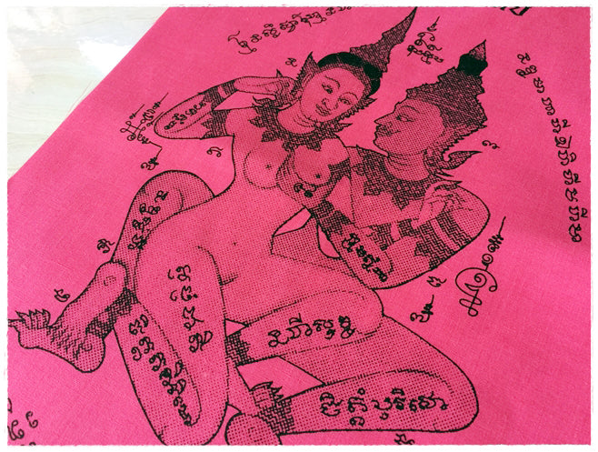 Thai sacred cloth for attraction featuring intricate designs and spiritual symbols on vibrant pink fabric