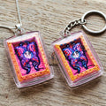 Authentic Thai Mini Butterfly King Amulet "Thep Chamlaeng Pamorn Purple Butterfly on Pink Background Hand-Painted Pendant" Consecrated by Khru Ba Krissana, Samnak Song Weruwan, Nakhon Ratchasima B.E. 2562 (2019)