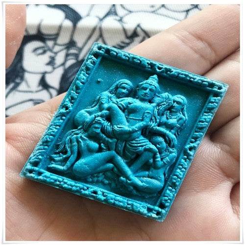 Thai seduction charm talisman featuring intricate design and vibrant turquoise color for spiritual enhancement