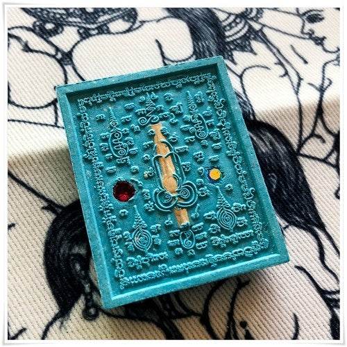 Thai seduction charm talisman in turquoise with intricate designs and gemstone accents for positive energy