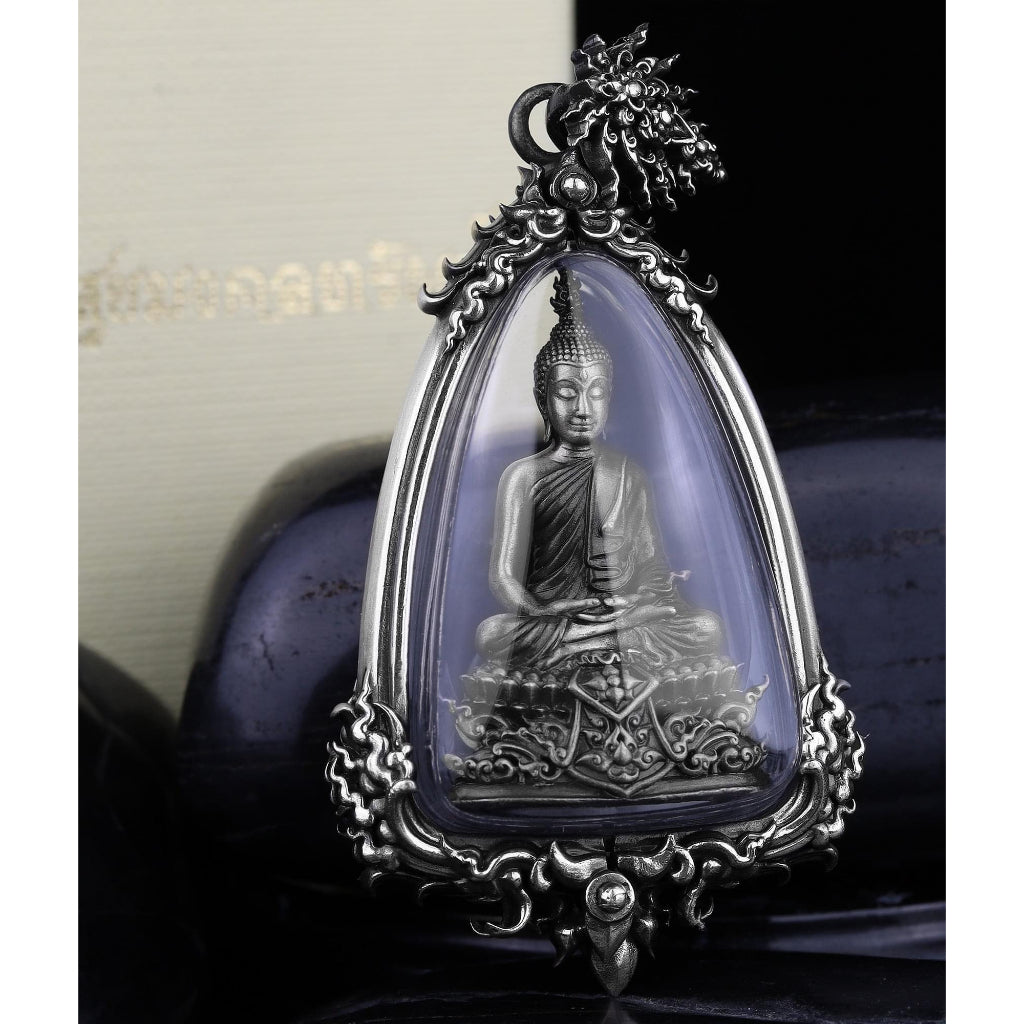 authentic silver Buddha amulet for protection in ornate silver frame with seated Buddha in clear protective case