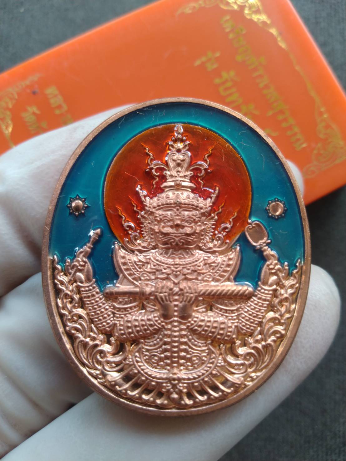 Taow Wessuwan wealth coin amulet copper oval pendant with teal and orange enamel background