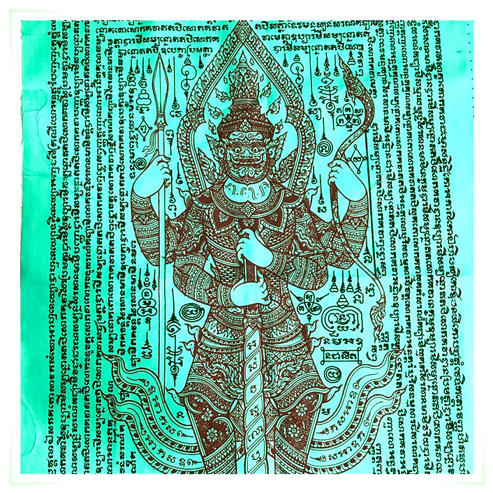 Green Thao Wessuwan yantra cloth showing ornate guardian deity holding a staff amid protective Thai script yantra