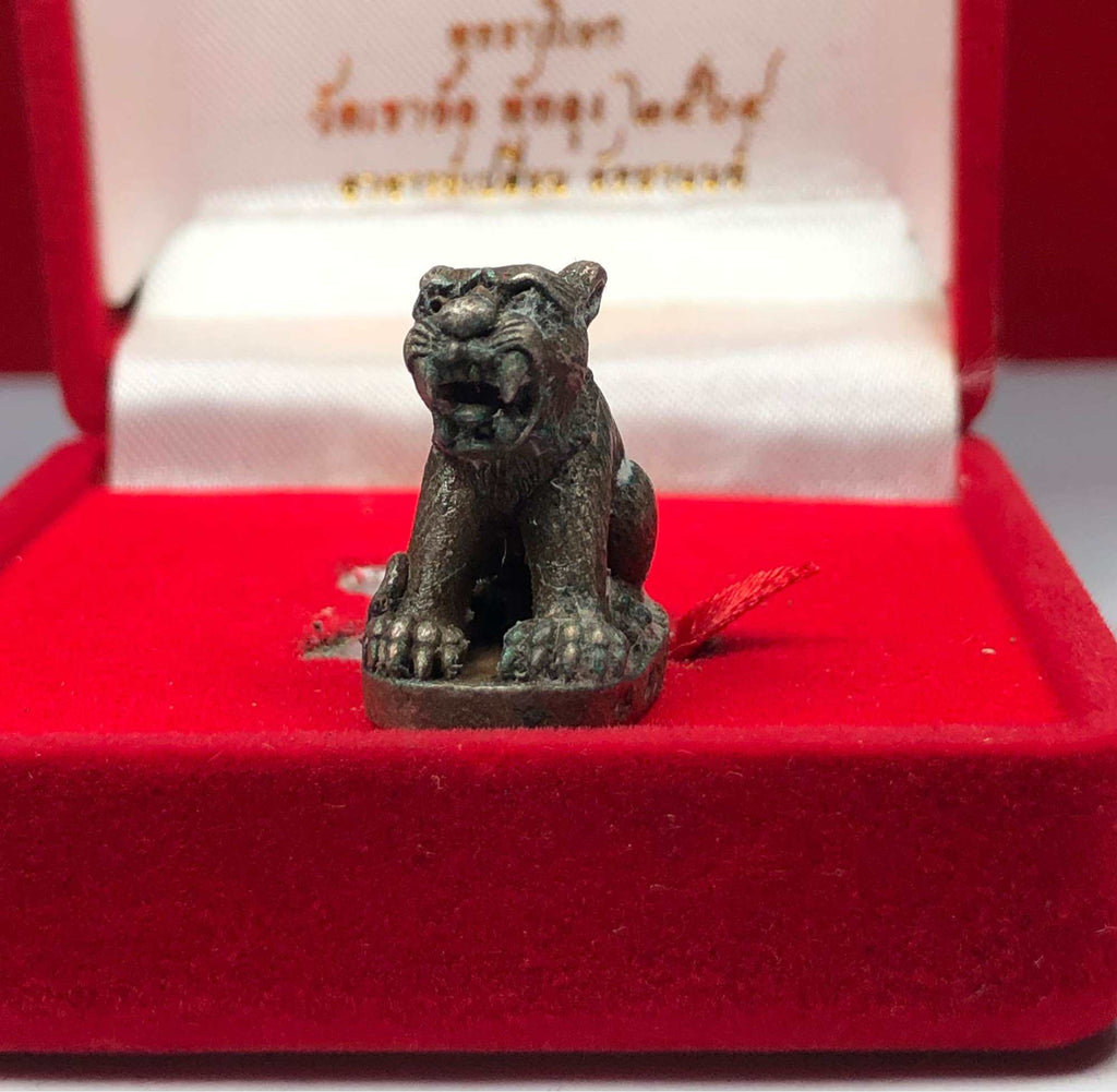 Small detailed Thai tiger amulet for protection figurine displayed in a red velvet box