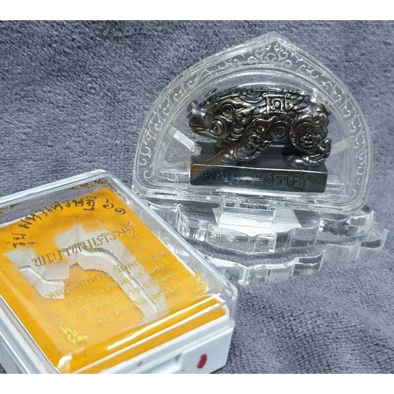 Thai wealth pig amulet encased in a decorative holder, symbolizing prosperity and good fortune