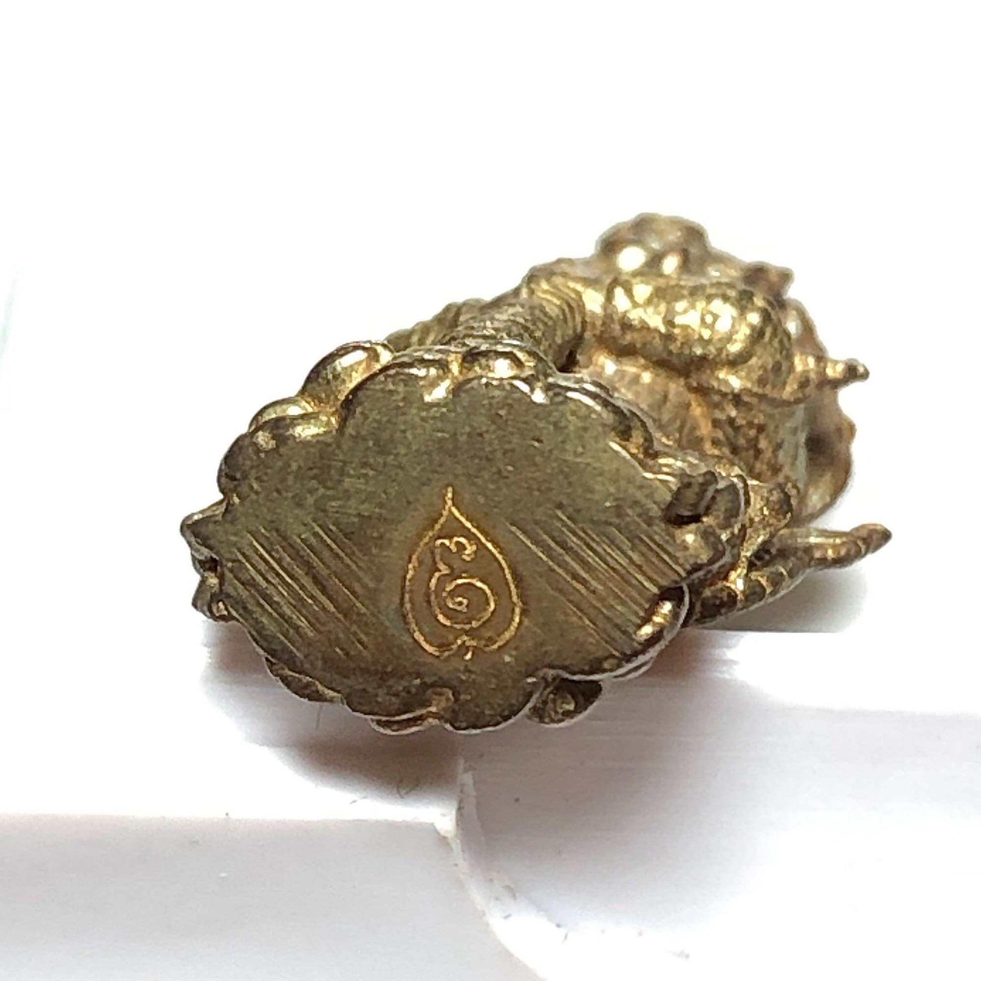 Thai wealth protection amulet with intricate detailing and a gold finish for enhanced prosperity