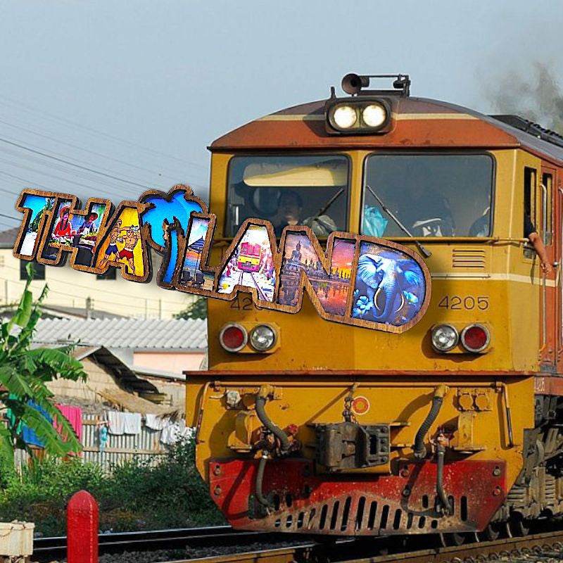 Yellow train with thai wood magnet souvenir spelling Thailand on the front of the engine