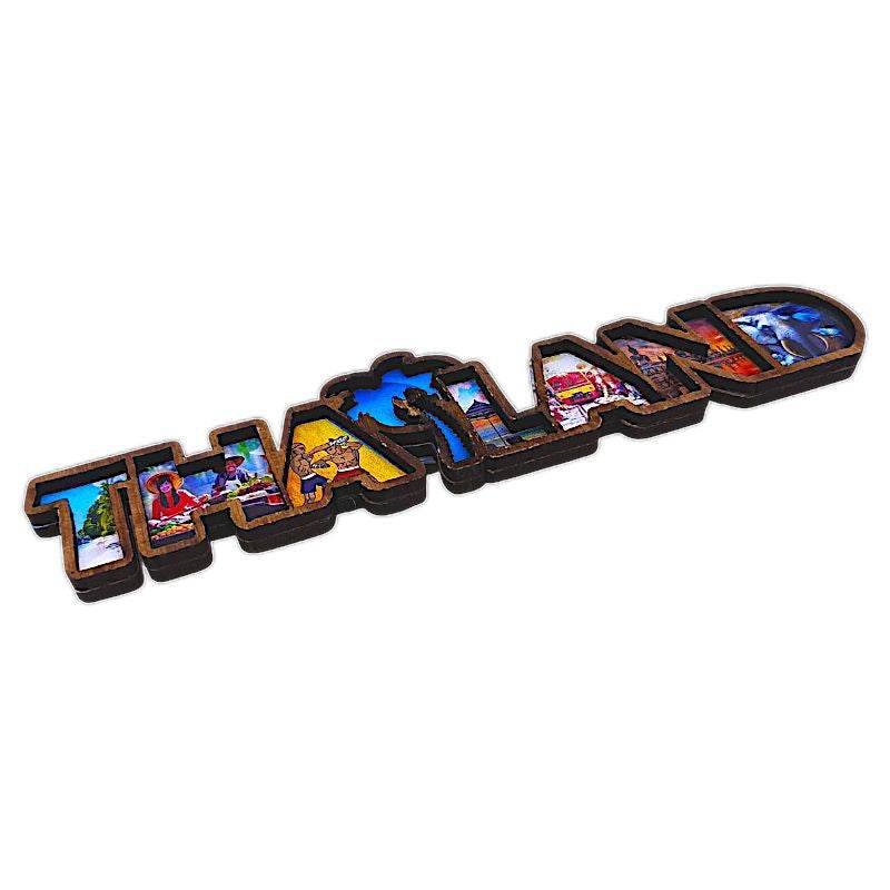 Thai wood magnet souvenir with colorful THAILAND letters and cultural images from One-Sake.com