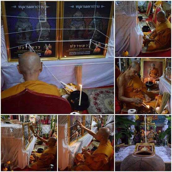Monks blessing Hanuman Maha Prap Amulet at shrine with framed images incense candles and sacred white threads