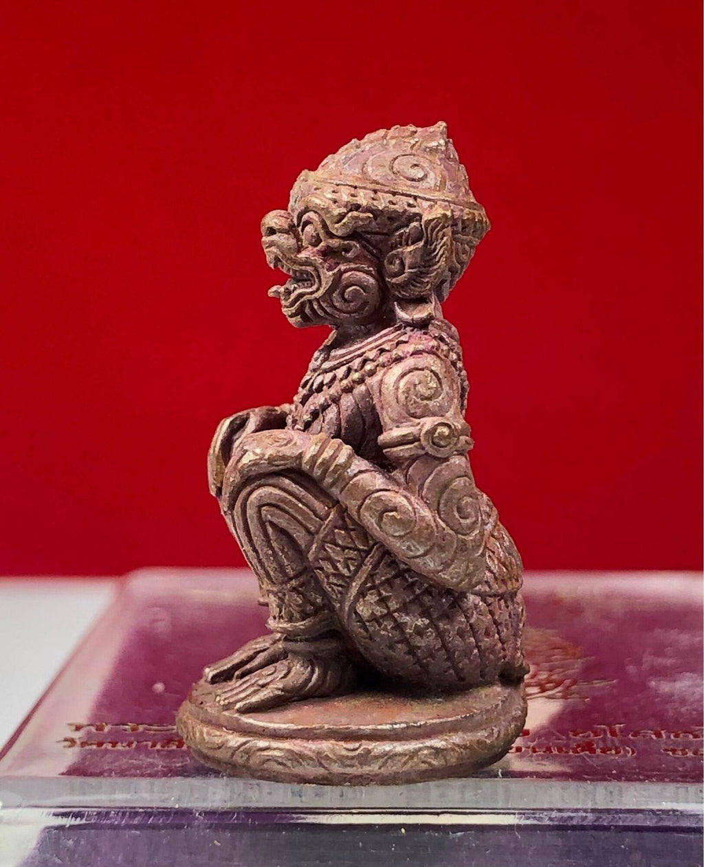 Hanuman Maha Prap Amulet bronze kneeling monkey deity figurine with intricate carvings on display