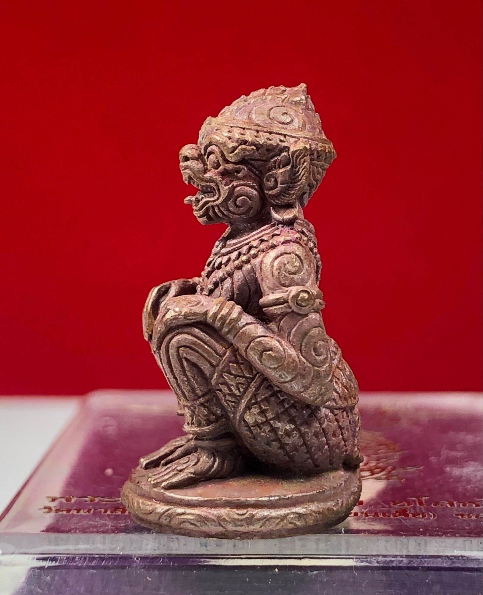 Hanuman Maha Prap Amulet bronze kneeling monkey deity figurine with intricate carvings on display