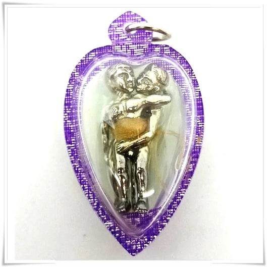LGBTQ love attraction amulet heart shaped purple casing with silver embracing couple figurine encased in clear plastic
