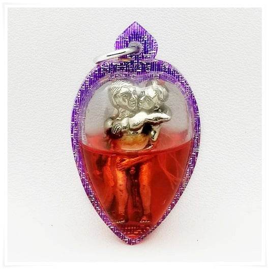 Thai Blessing Co purple teardrop pendant featuring a silver embracing couple in red resin LGBTQ love attraction amulet