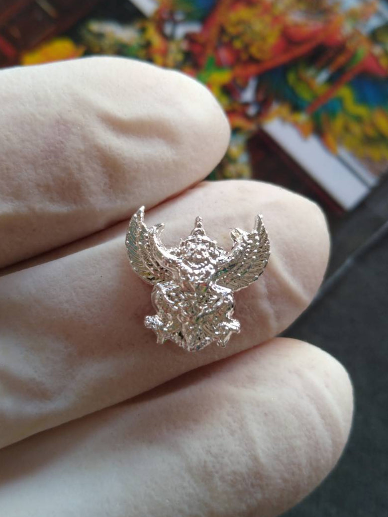 Thai Blessing Co silver mini Garuda amulet Thailand detailed small Garuda pendant held between gloved fingers