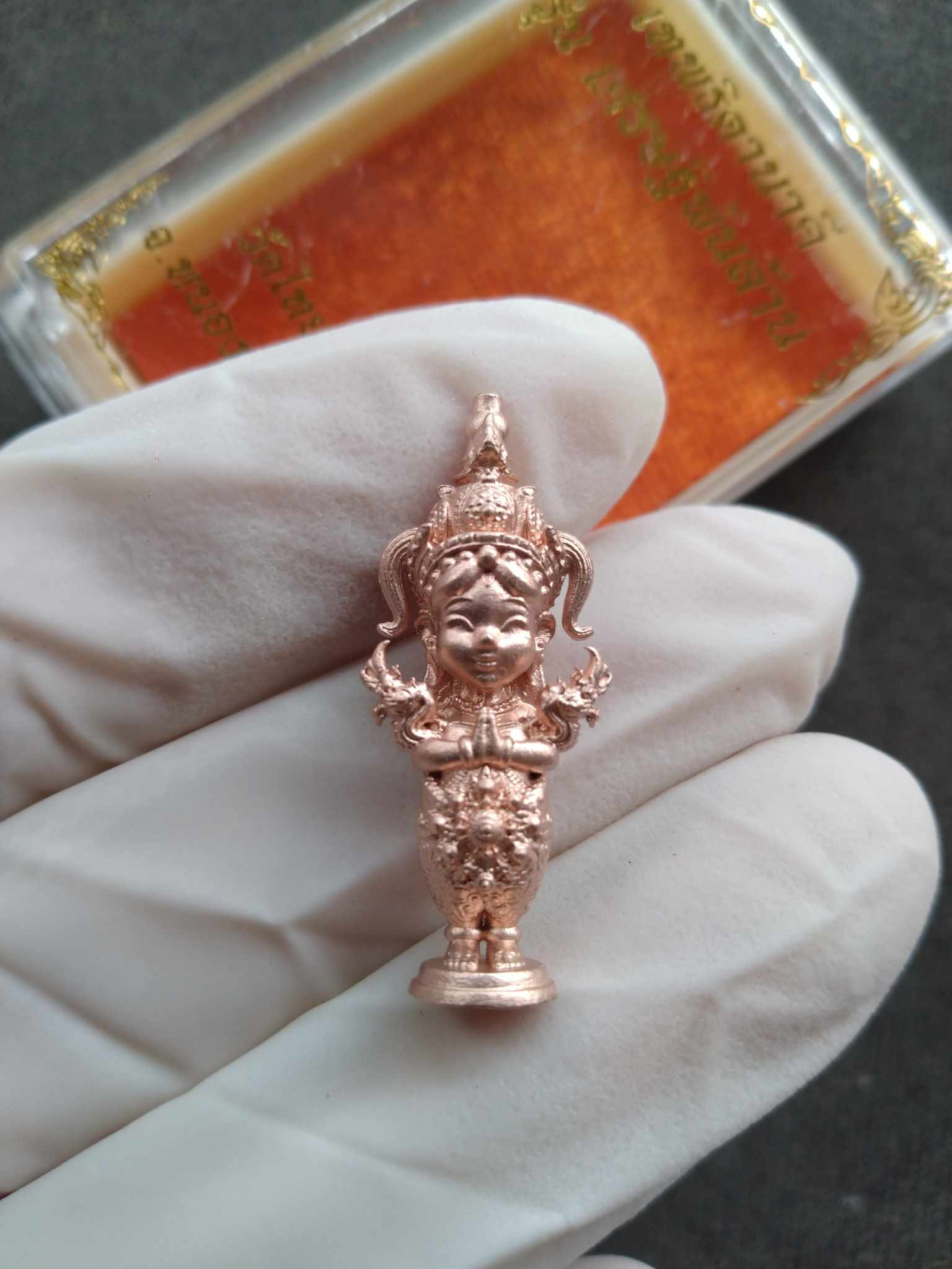 Handheld rose gold Nakee Goddess – Billionaire Edition Sacred Thai Amulet for Wealth statue held with white glove