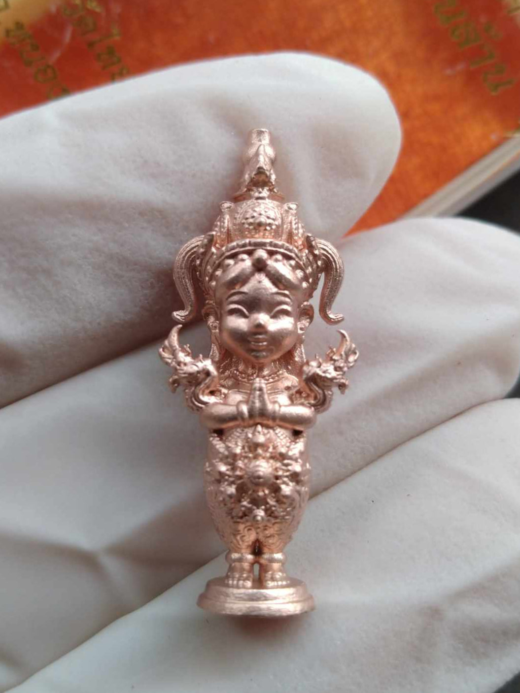 Nakee Goddess – Billionaire Edition Sacred Thai Amulet for Wealth copper figurine held in gloved hand showing intricate details