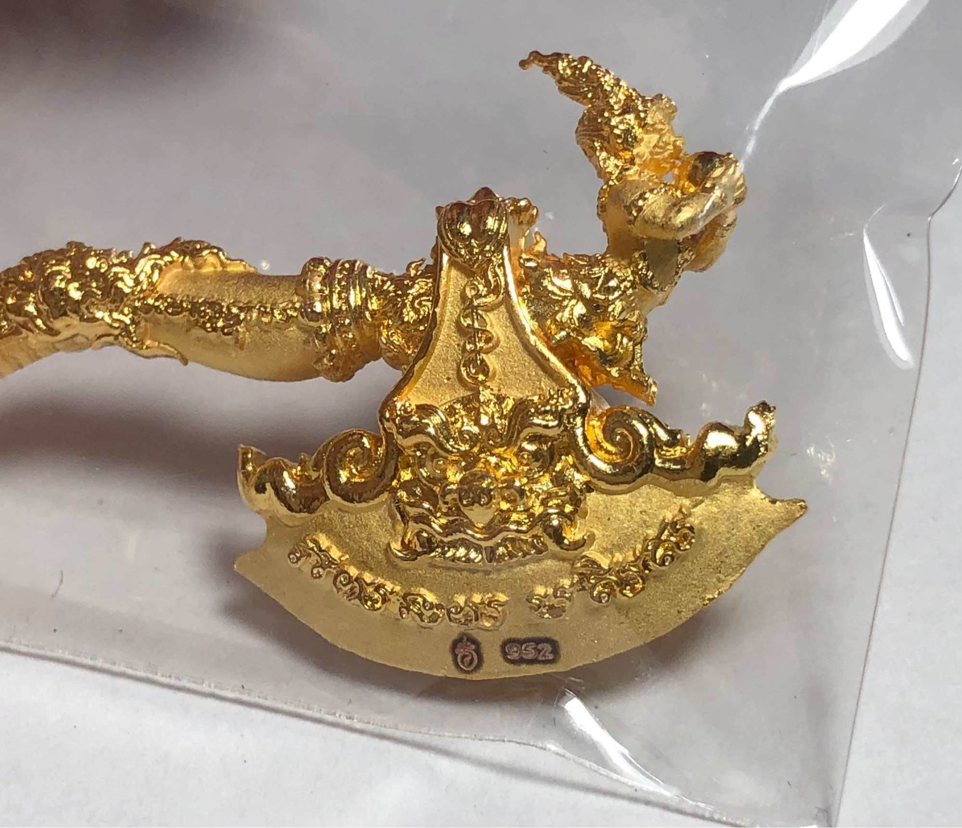 Gold ornate Phaya Khwan Maha Prap Amulet Tak Sila Edition with Naga serpent detail and Thai inscriptions